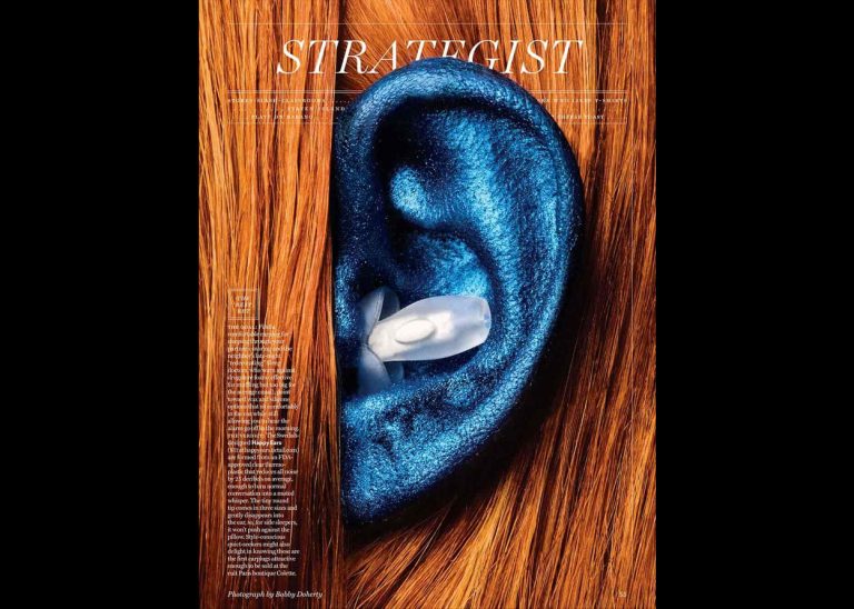 Strategist magazine cover showing a blue ear with Happy ears earplug inside the ear