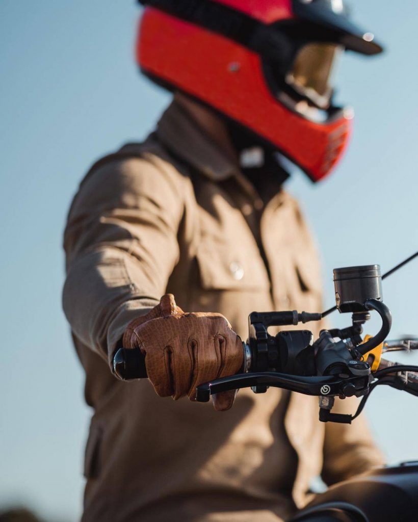 Guy with helmet riding motorcycle wearing Happy Ears Earplugs